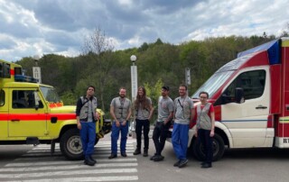 A team of medical workers from CADUS between two ambulances.